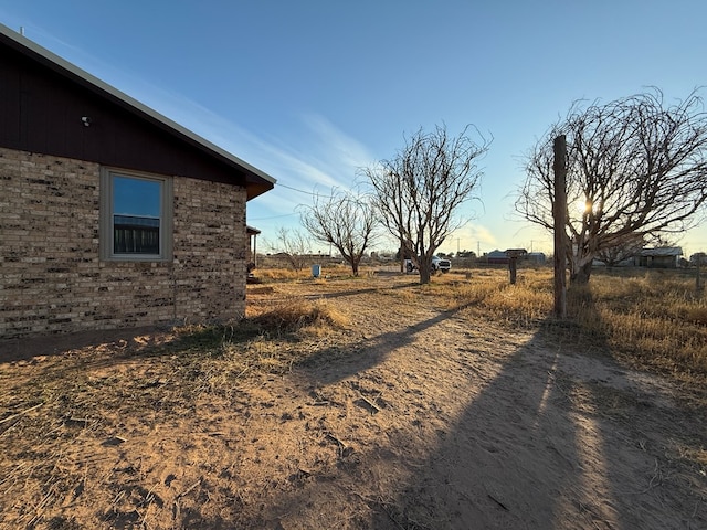 view of yard with a rural view