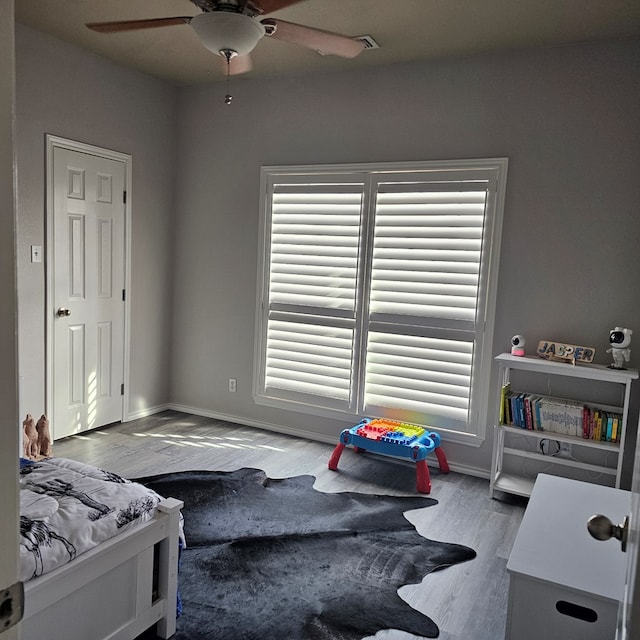 bedroom with hardwood / wood-style floors and ceiling fan