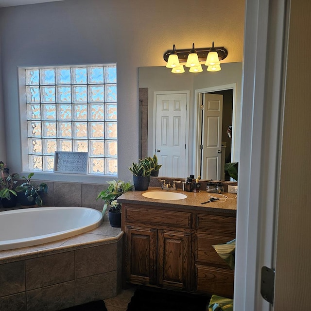 bathroom with a relaxing tiled tub and vanity