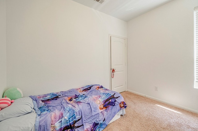 bedroom featuring light carpet