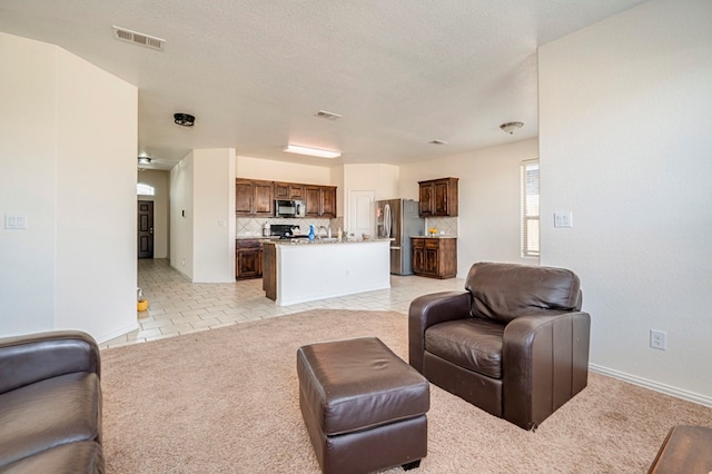 living room with light tile patterned flooring and a textured ceiling