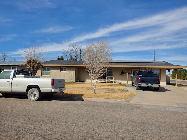 view of front of property featuring solar panels