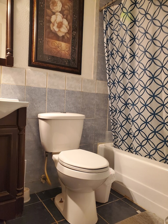 full bathroom featuring tile patterned flooring, shower / bath combination with curtain, toilet, and tile walls