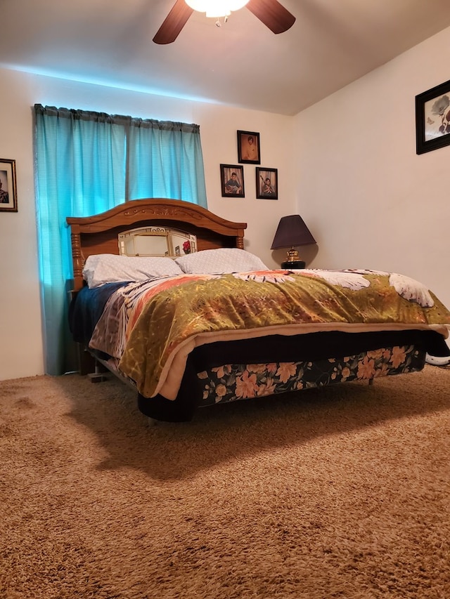 bedroom featuring ceiling fan and carpet