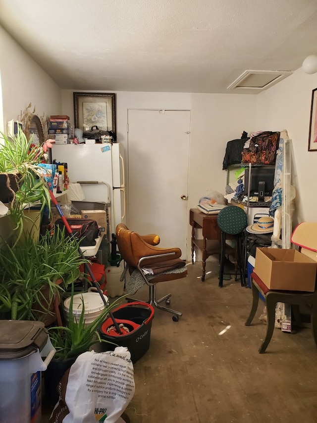 miscellaneous room featuring a textured ceiling and concrete floors