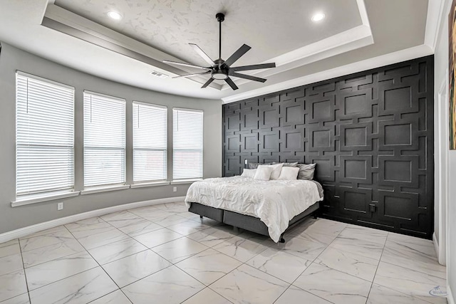 bedroom with a tray ceiling and ceiling fan