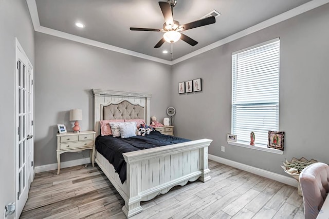 bedroom featuring ceiling fan, ornamental molding, and light hardwood / wood-style flooring