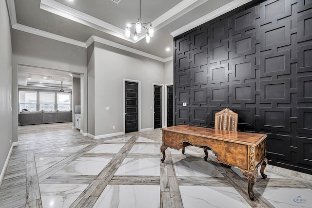 office space featuring a raised ceiling, ornamental molding, and a high ceiling