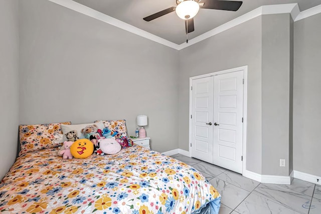 bedroom with ornamental molding, ceiling fan, and a closet