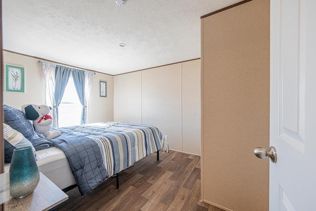 bedroom with wood-type flooring and a textured ceiling