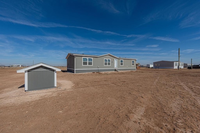 view of front of property with a shed