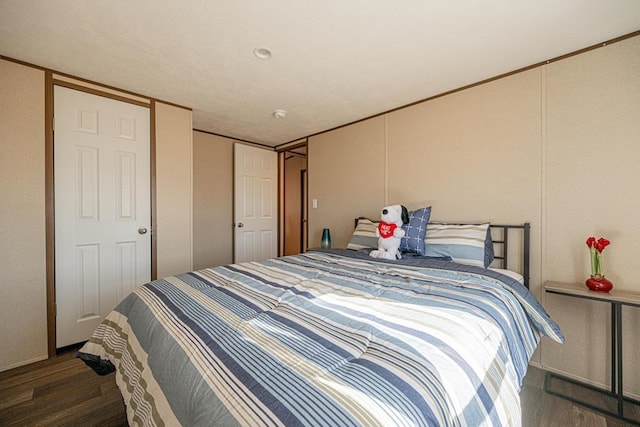 bedroom with dark wood-type flooring