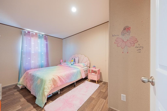 bedroom with wood-type flooring