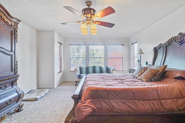 bedroom featuring a textured ceiling, carpet floors, and ceiling fan