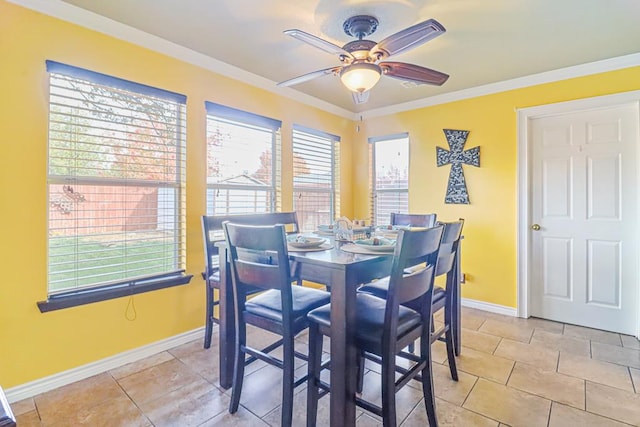 dining area with ceiling fan, crown molding, light tile patterned flooring, and a healthy amount of sunlight