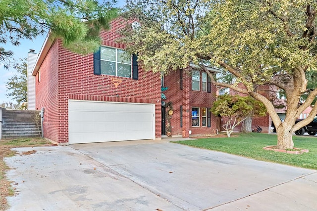 view of front of property with a front yard and a garage