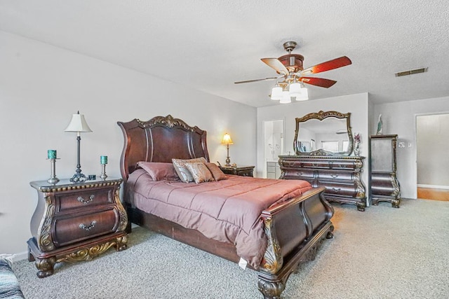 bedroom featuring carpet flooring, ceiling fan, a textured ceiling, and connected bathroom