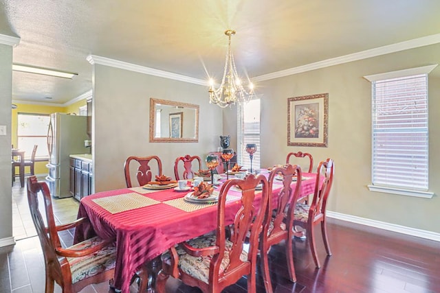 dining area with a notable chandelier, dark hardwood / wood-style floors, crown molding, and a textured ceiling