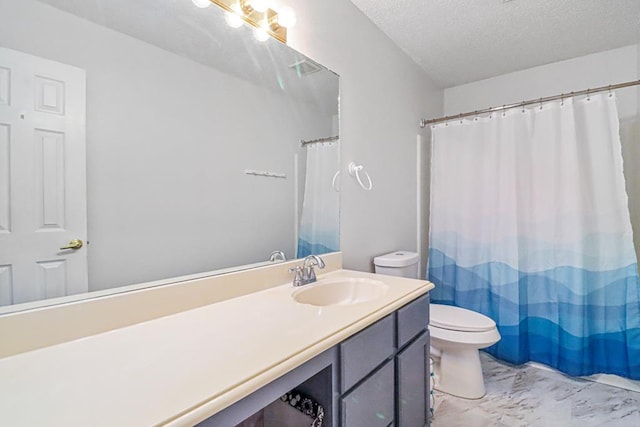 bathroom featuring vanity, a textured ceiling, and toilet