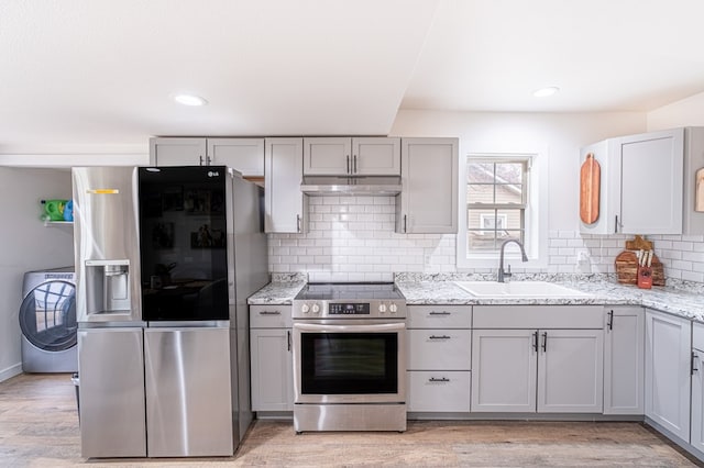 kitchen featuring washer / clothes dryer, gray cabinets, and stainless steel appliances