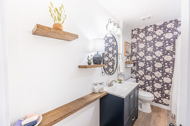 bathroom with vanity, hardwood / wood-style floors, and toilet