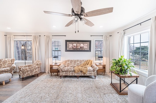 living room featuring wood-type flooring and ceiling fan