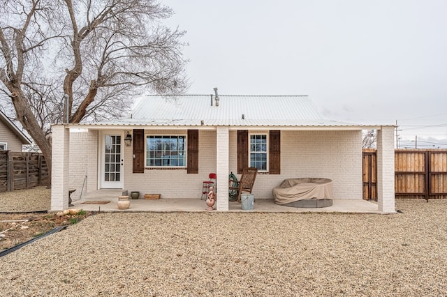 back of property with a patio