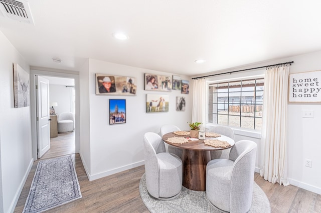 dining space with light hardwood / wood-style floors