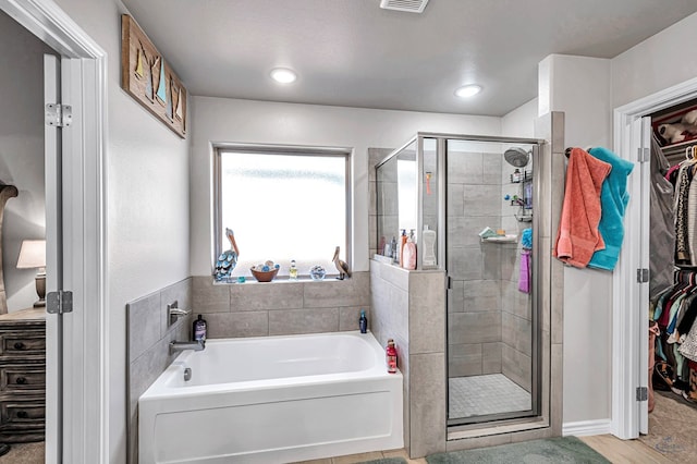 bathroom with separate shower and tub