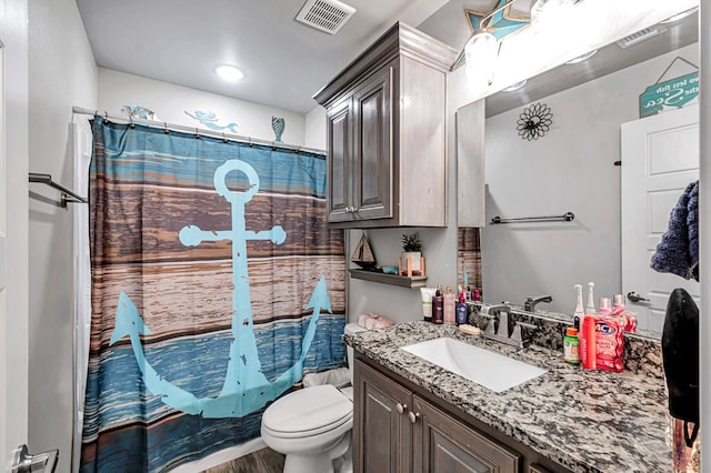 bathroom with hardwood / wood-style flooring, vanity, toilet, and curtained shower