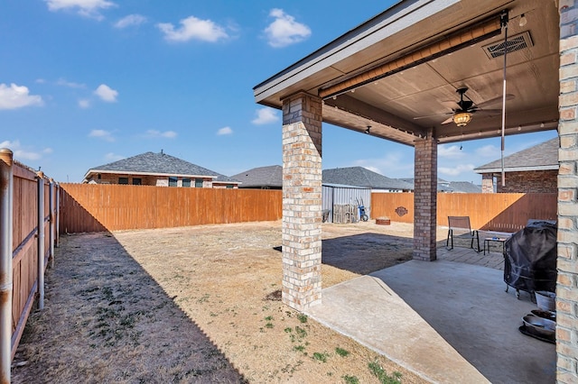 view of yard featuring a patio area and ceiling fan