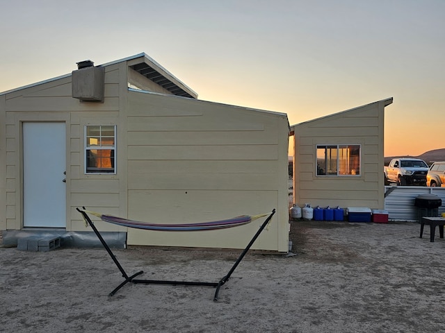 view of back house at dusk