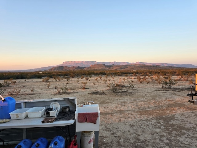 yard at dusk with a mountain view