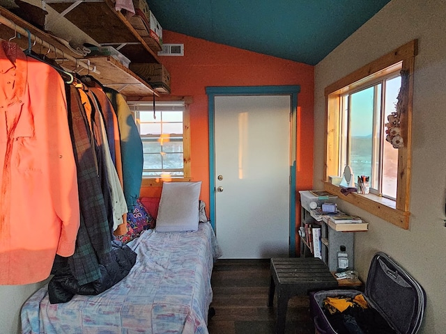 bedroom with hardwood / wood-style flooring and lofted ceiling