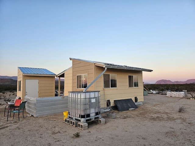 back house at dusk with a mountain view