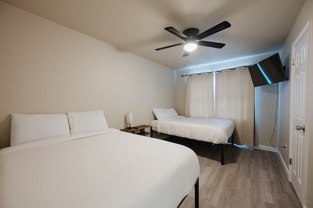 bedroom with ceiling fan and light hardwood / wood-style floors