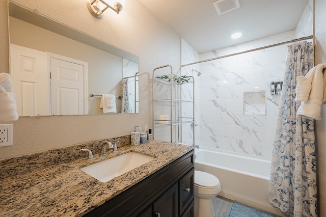 full bathroom with toilet, vanity, and shower / tub combo with curtain