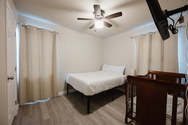 bedroom featuring light hardwood / wood-style flooring and ceiling fan