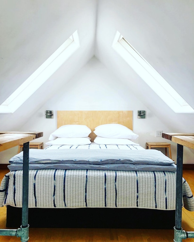 bedroom featuring wood-type flooring and lofted ceiling