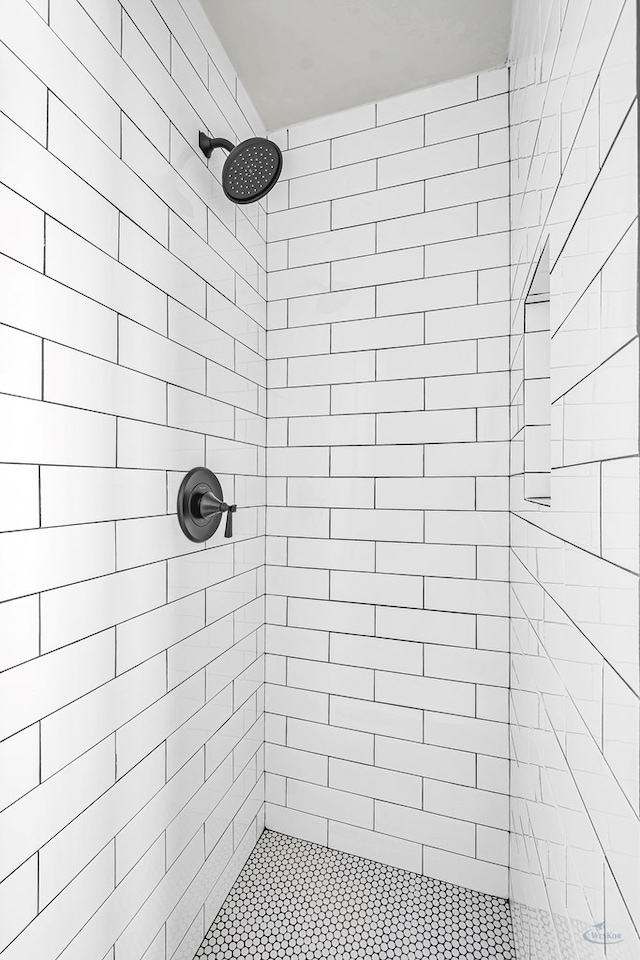 bathroom with tiled shower