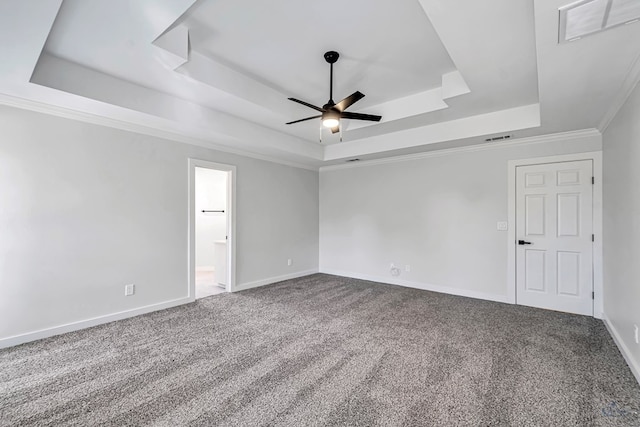 carpeted empty room with ceiling fan, a raised ceiling, and ornamental molding