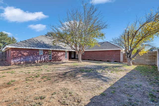 back of house with a lawn