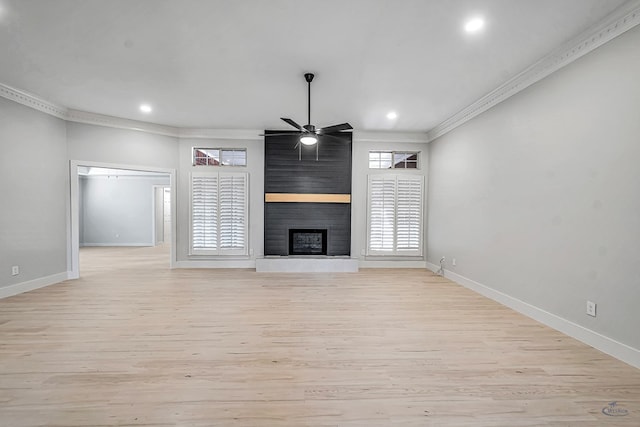 unfurnished living room with ceiling fan, a fireplace, crown molding, and light hardwood / wood-style flooring