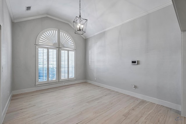 spare room featuring a notable chandelier, light hardwood / wood-style floors, lofted ceiling, and ornamental molding