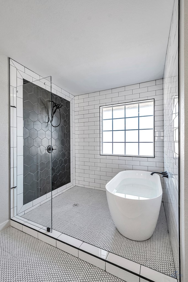 bathroom featuring separate shower and tub and tile patterned flooring