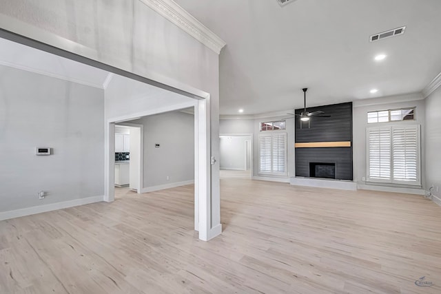 unfurnished living room with ceiling fan, a large fireplace, ornamental molding, and light hardwood / wood-style flooring