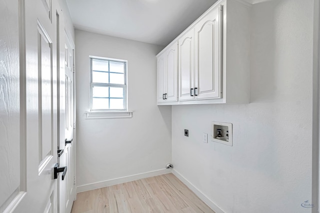 washroom featuring hookup for a washing machine, cabinets, light wood-type flooring, and hookup for an electric dryer