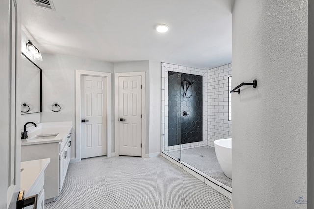 bathroom featuring tile patterned floors, vanity, and independent shower and bath