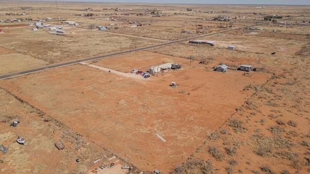 bird's eye view with view of desert and a rural view