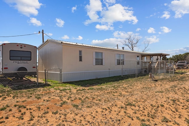 rear view of property with fence and metal roof